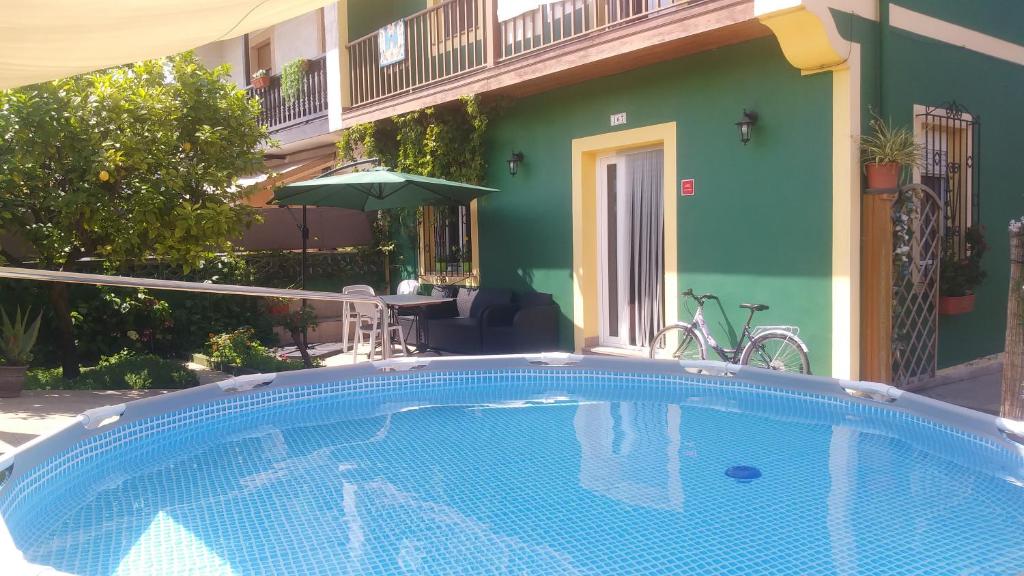 a swimming pool in front of a house at Casa entre "Mar y Montaña" centro de Cantabria, terraza, ajardinada, amplia y luminosa, hasta 10 personas in Puente San Miguel