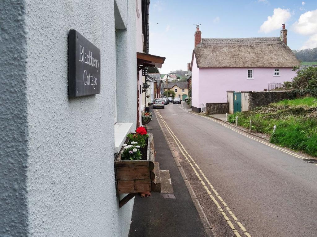 a sign on the side of a building on a street at Blackberry Cottage in Kenton