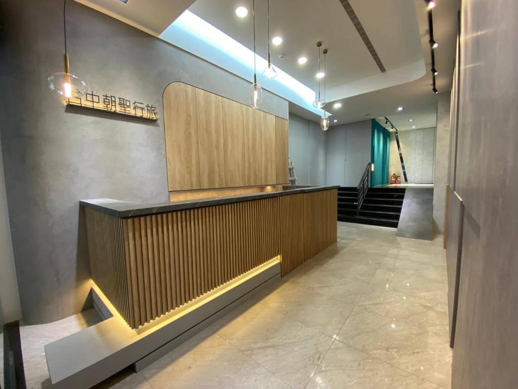 a lobby with a counter and stairs in a building at Taichung saint hotel in Taichung