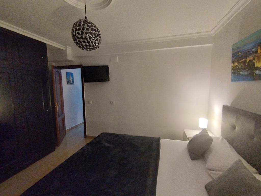 Postel nebo postele na pokoji v ubytování RINCÓN MURALLA DE LA MACARENA