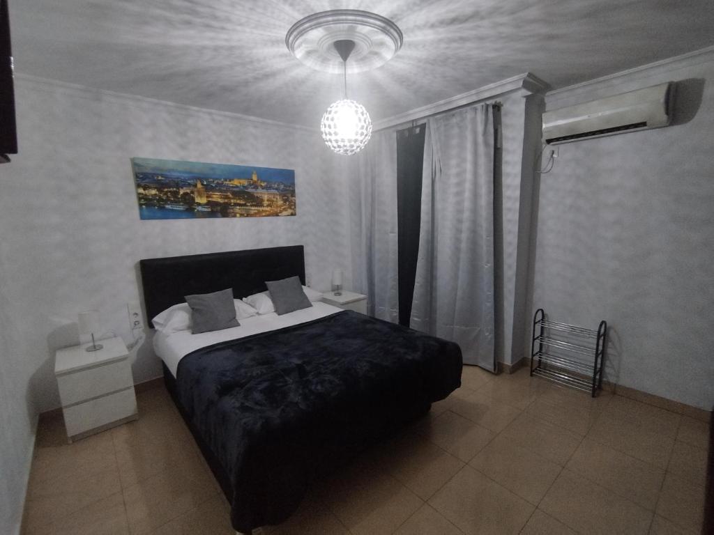 Postel nebo postele na pokoji v ubytování RINCÓN MURALLA DE LA MACARENA
