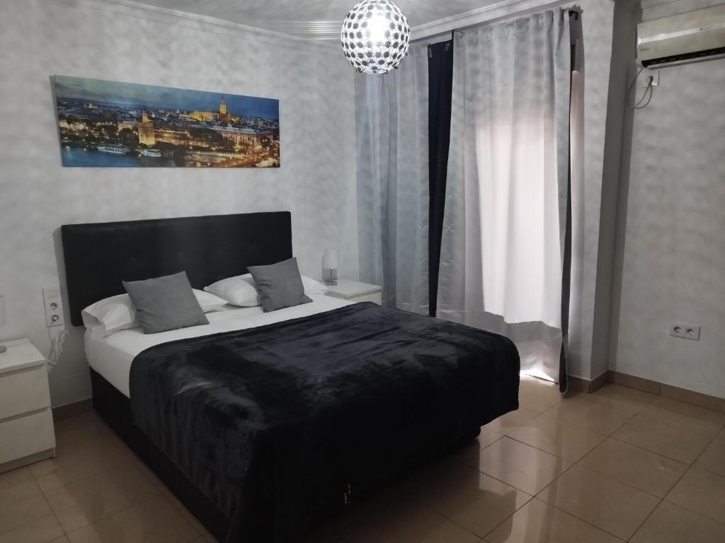 Postel nebo postele na pokoji v ubytování RINCÓN MURALLA DE LA MACARENA