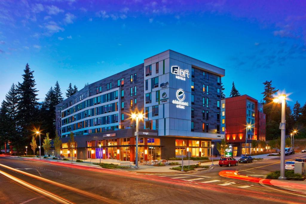 a building with a sign on it on a city street at Aloft Seattle Redmond in Redmond