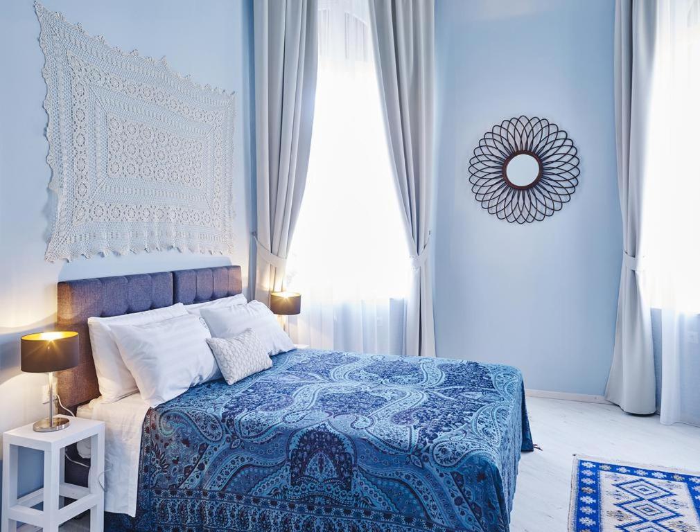 um quarto azul com uma cama com um cobertor azul e branco em Villa Sanyan - Adults Only em Rodes