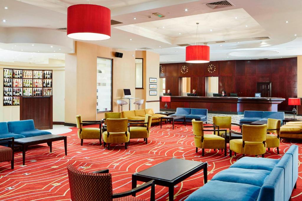 a lobby of a hotel with chairs and tables at Glasgow Marriott Hotel in Glasgow