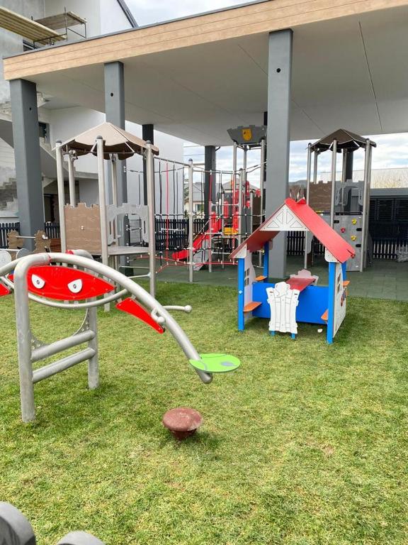 a playground with play equipment on the grass at Kapitańska 16C31 in Grzybowo