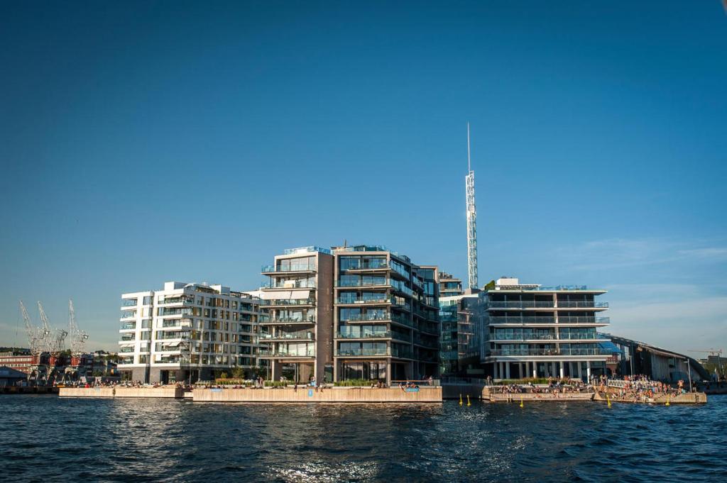a group of tall buildings next to a body of water at Tjuvholmen - ved Aker Brygge in Oslo