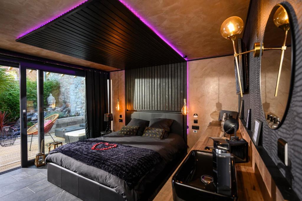a bedroom with a large bed and a mirror at Spa Maroilles in Maroilles