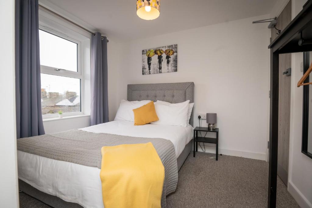 sypialnia z dużym łóżkiem z żółtymi poduszkami w obiekcie Self containted 1 Bed modern apartment- Meters from Beach w mieście Great Yarmouth