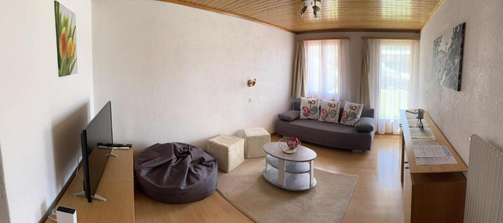 a living room with a couch and a table at Gaby in Grächen