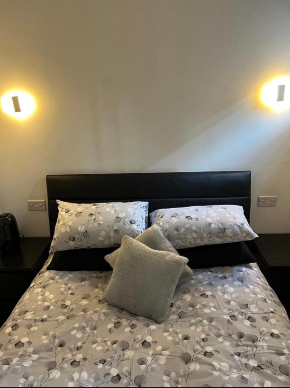 a bed with two pillows on top of it at Modern flat in Maidstone in Kent
