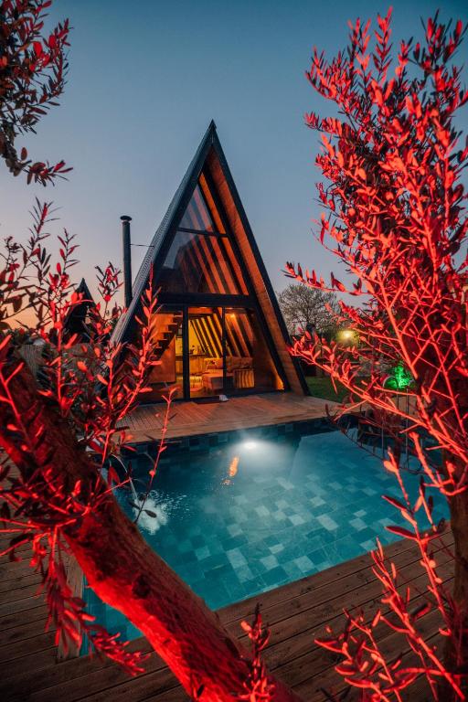a house with a swimming pool at night at KARMATTE BUNGALOW in Kartepe