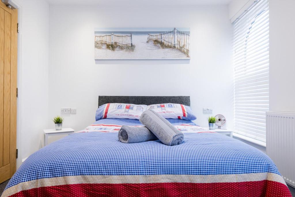 a bed with two pillows on it in a bedroom at Hillcrest Studio Apartments in Cleethorpes