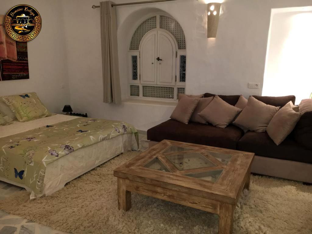 a living room with a couch and a coffee table at Suite Aurora Villa Naïa Domaine Béluga in Sidi el Moujahed