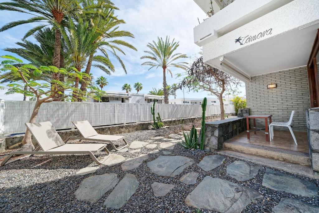 a patio with two chairs and a table at Apartamentos Tamara in Maspalomas