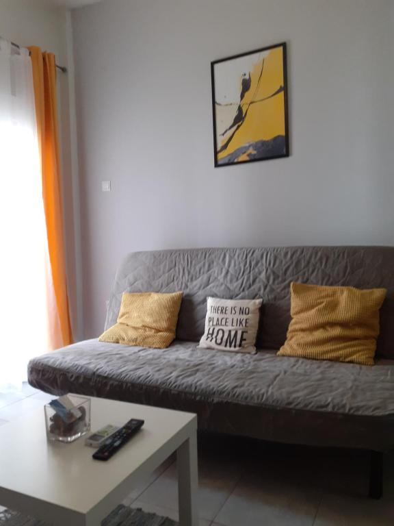 a living room with a couch and a coffee table at Central City Kristalli studio in Thessaloniki
