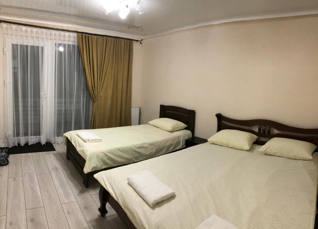 a bedroom with two beds and a window at Family House in Izki