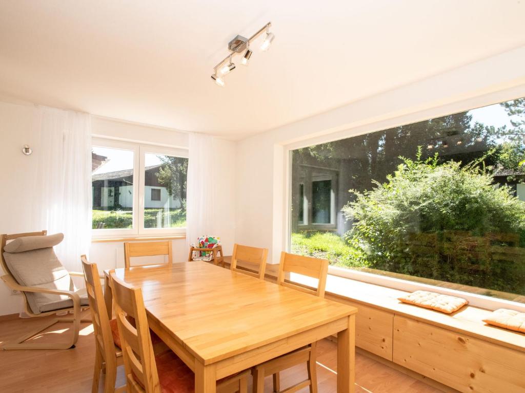 a dining room with a wooden table and a large window at Holiday home Reichenbach in Bayerstetten