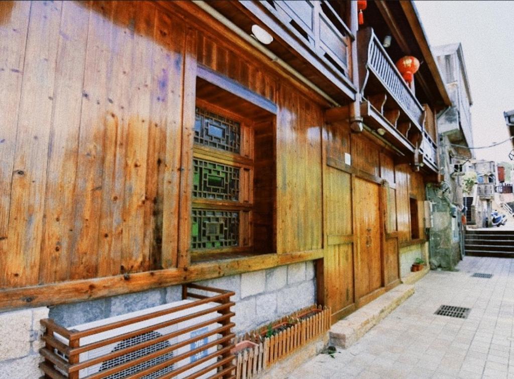 a wooden building with a bench in front of it at 小島上二館 in Chung-liu-ts'un