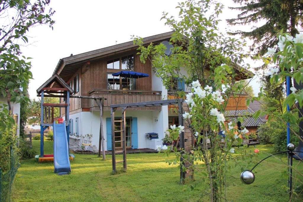 a house with a playground in the yard at Fewo Ammertal in Oberammergau