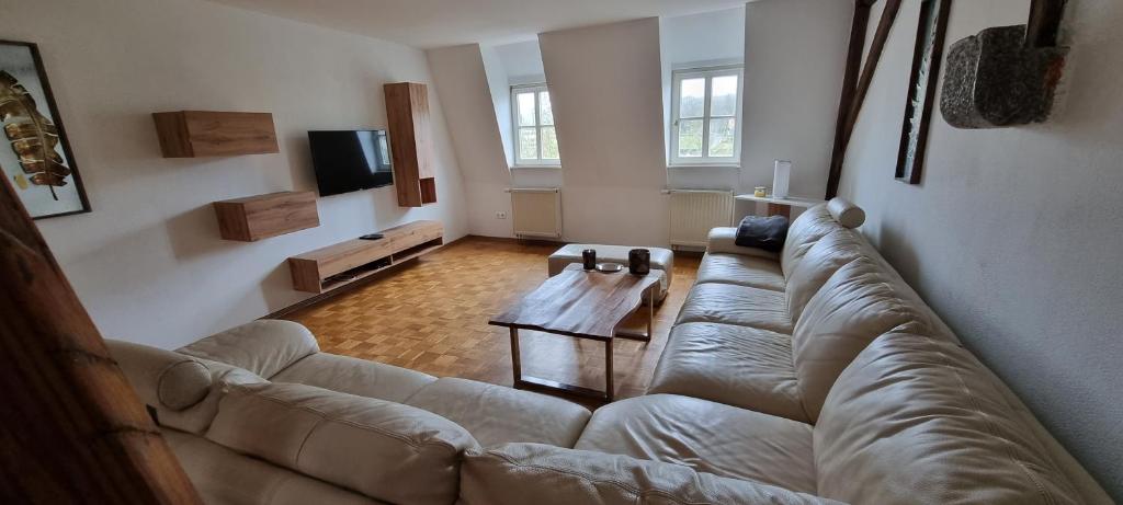 a living room with a couch and a coffee table at Apartment am Zolltor in Wertheim