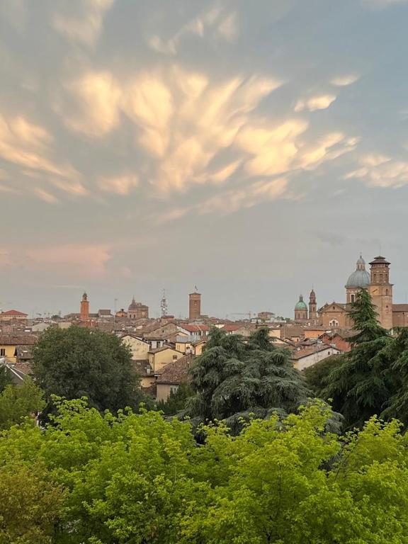 a view of a city with buildings and trees at App di Myrò in Reggio Emilia