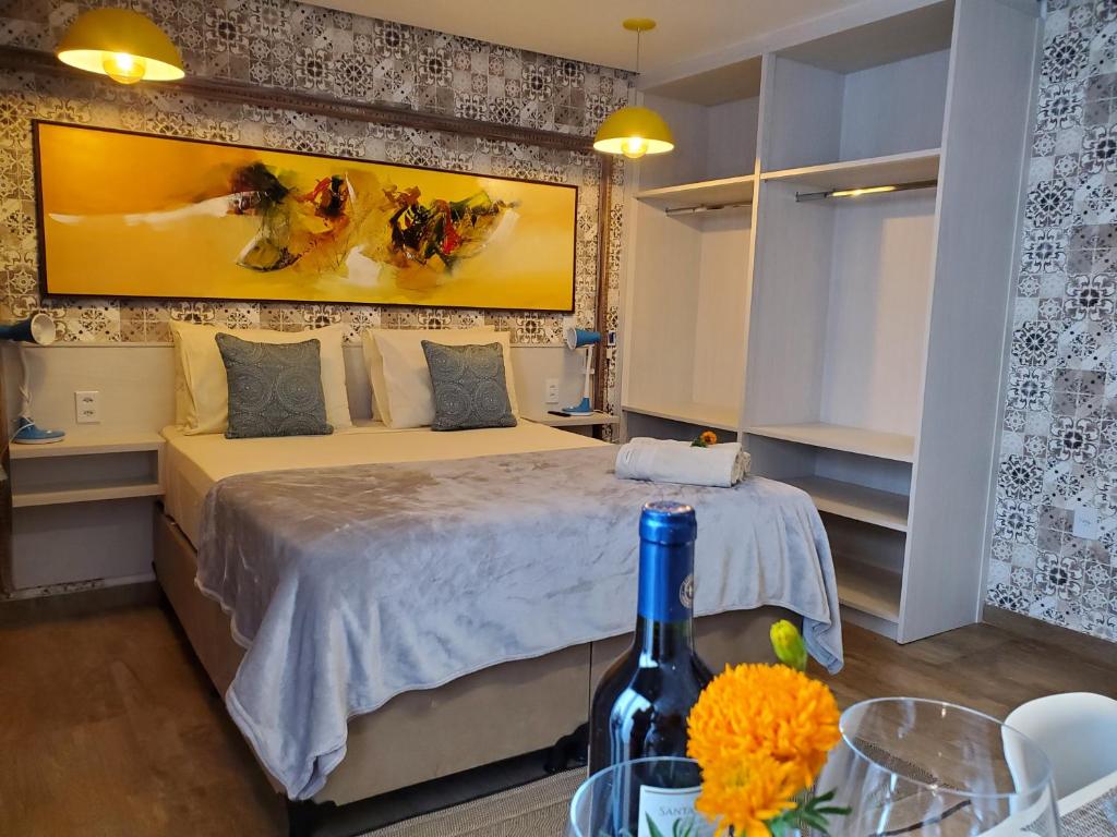 a bedroom with a bed and a bottle of wine at Villa Terragona in Alto Paraíso de Goiás