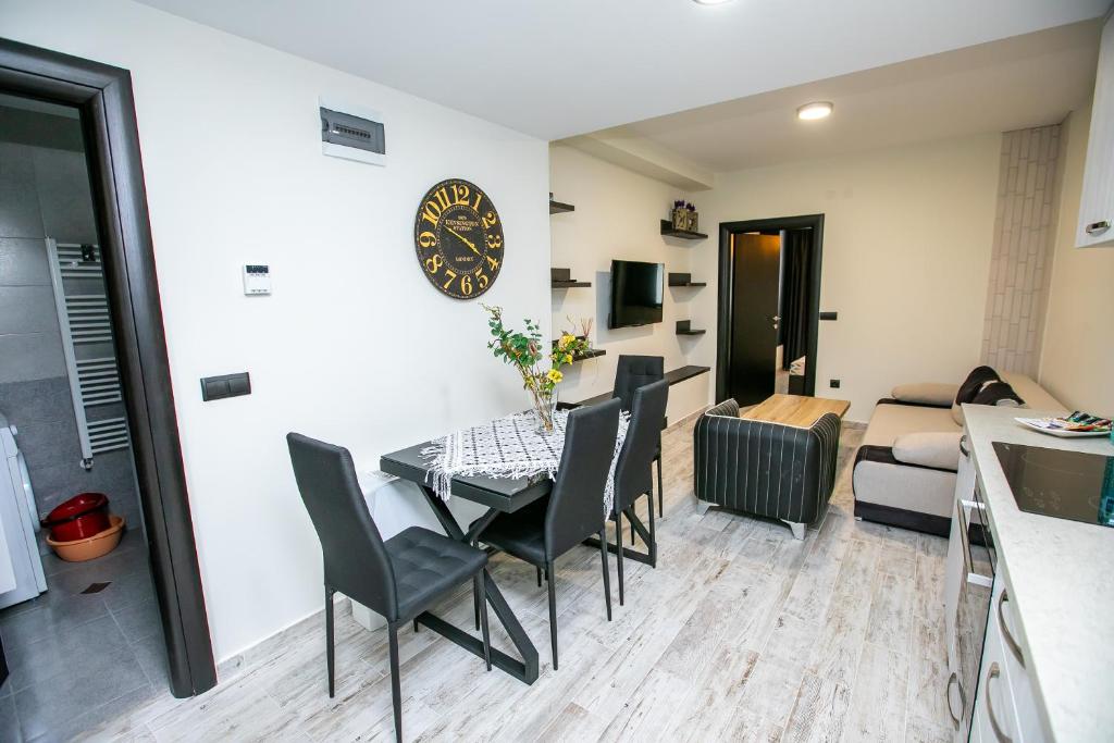 a dining room and living room with a table and chairs at Apartment Dafni in Sandanski