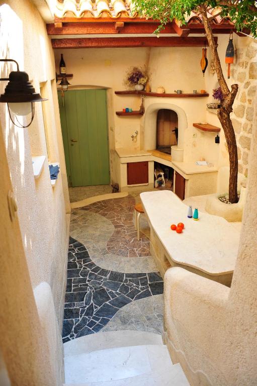 a living room with a green door and a table at Villa Ana in Rab