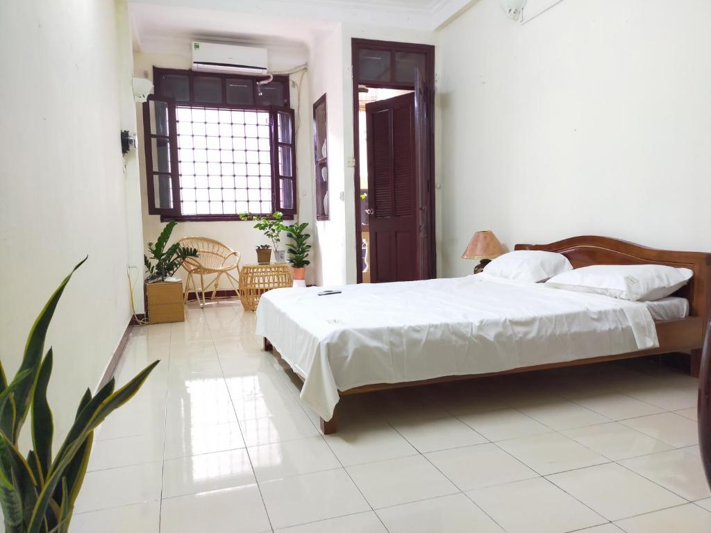 a bedroom with a large bed in a room at Tropical land little Hanoi homestay in Hanoi