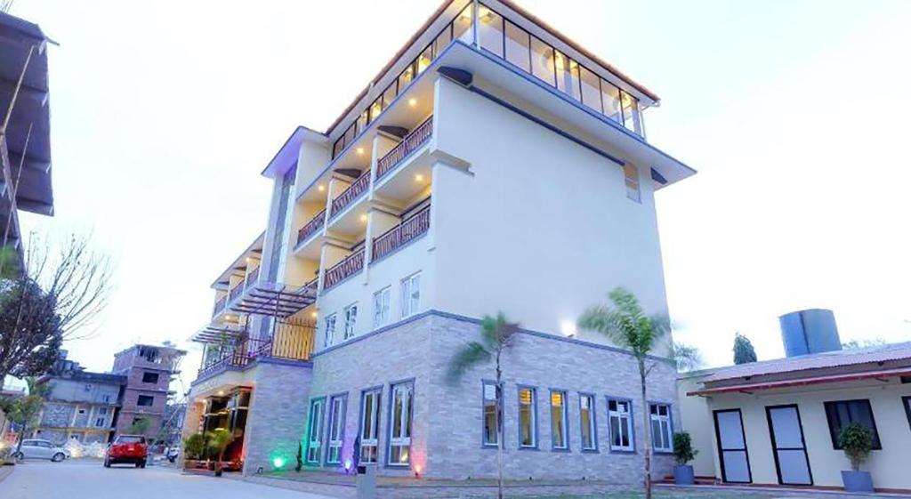 a large white building on a city street at Hotel Glory Garden in Pokhara