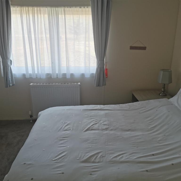 Postel nebo postele na pokoji v ubytování Homeston Lodge