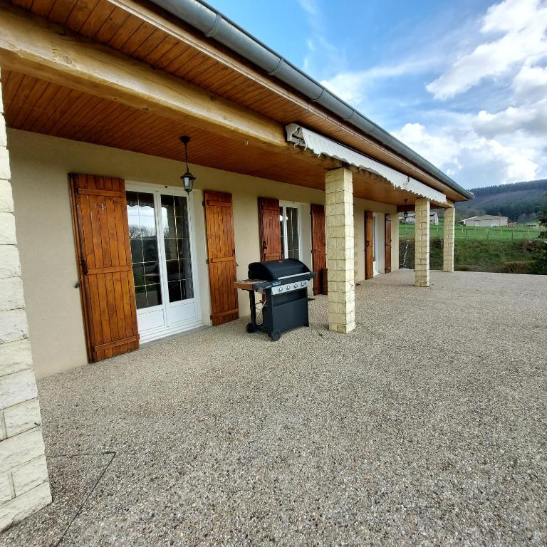 a porch of a house with a piano on it at LE VIEUX SAULE in Curgy