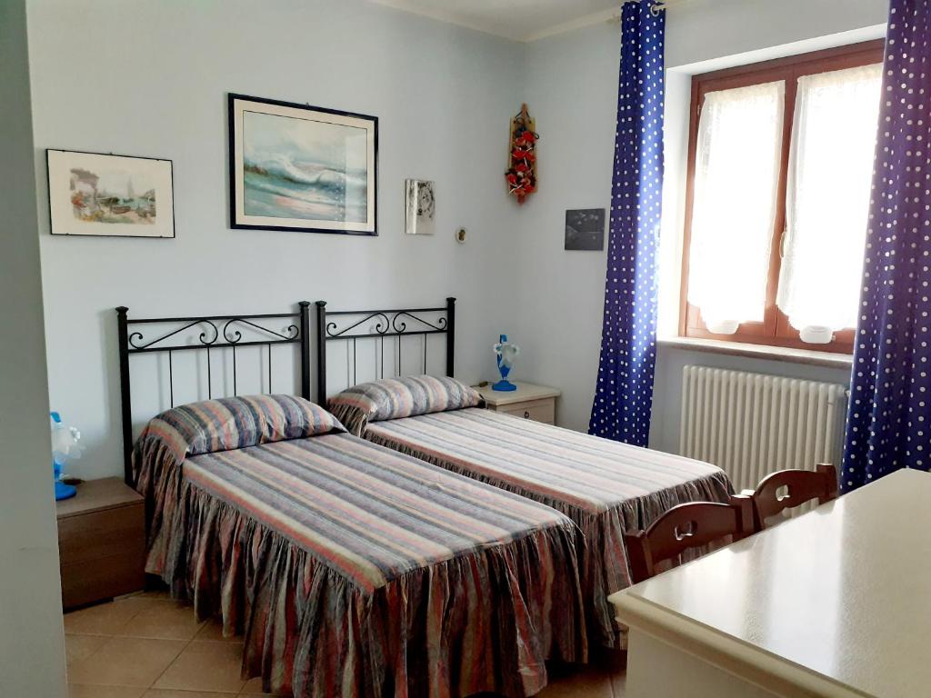 Postel nebo postele na pokoji v ubytování La Casa Più Sù