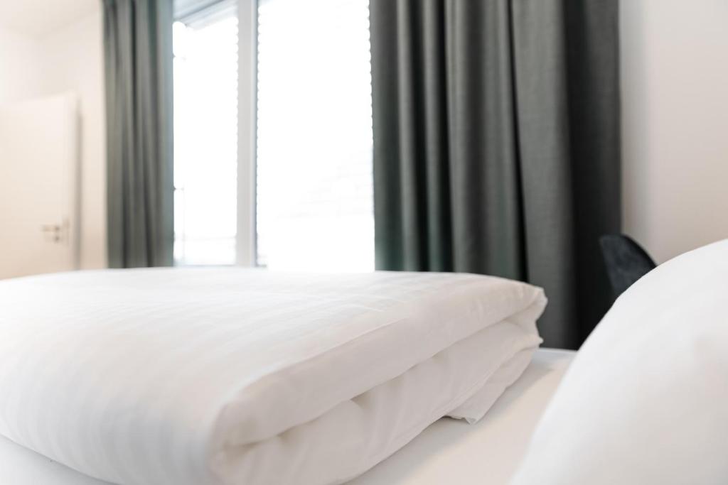 Postel nebo postele na pokoji v ubytování Boardinghouse Plattling
