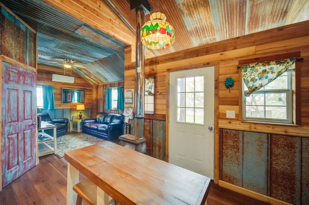 a living room with a wooden ceiling and a door at Pet-Friendly Kerrville Vacation Rental Farmhouse in Kerrville