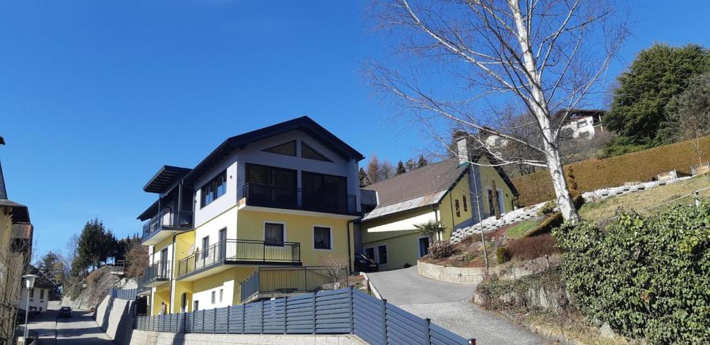 a large yellow house with a black roof at Lucashof Millstättersee in Millstatt