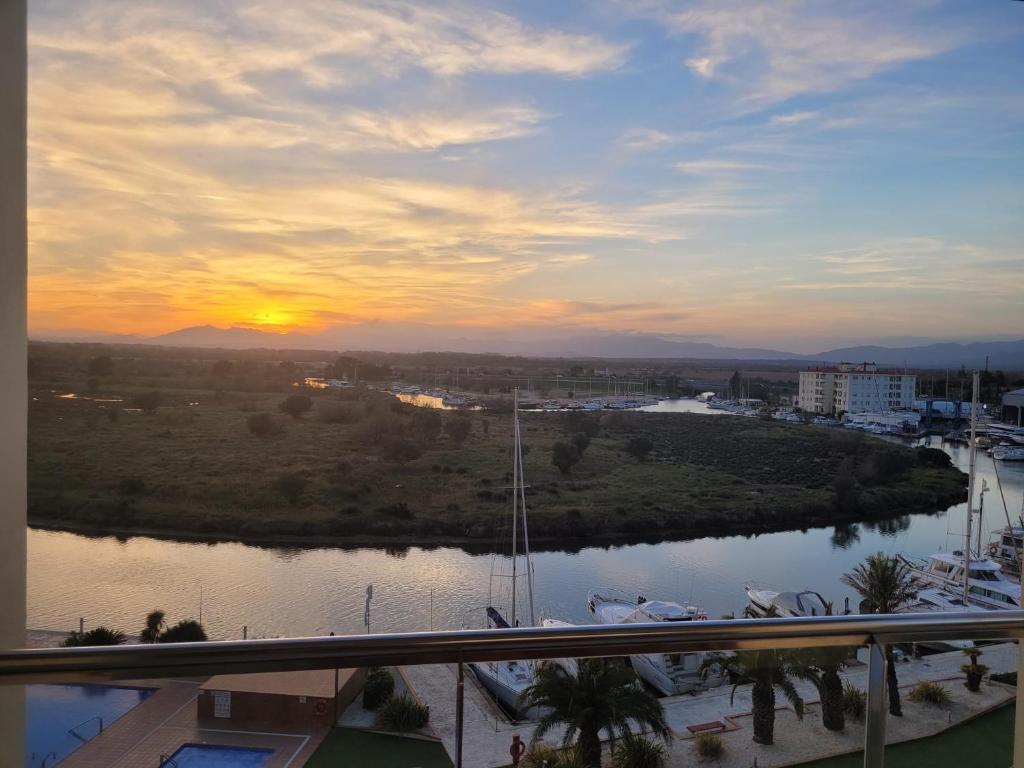 a view of a river at sunset from a balcony at Atico en Port gran Roses in Roses
