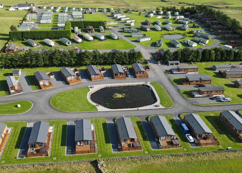 an aerial view of a building lot with houses at Whitecairn Holiday Park in Glenluce