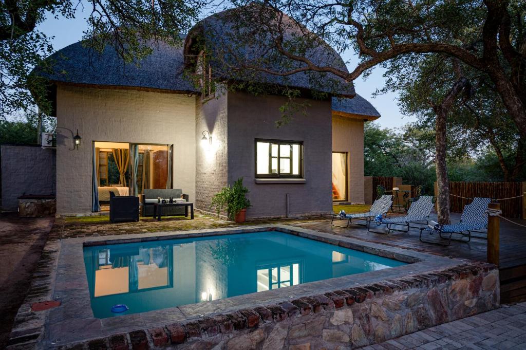 una casa con piscina delante en Nkanyi Wildlife House & Cottage, en Hoedspruit