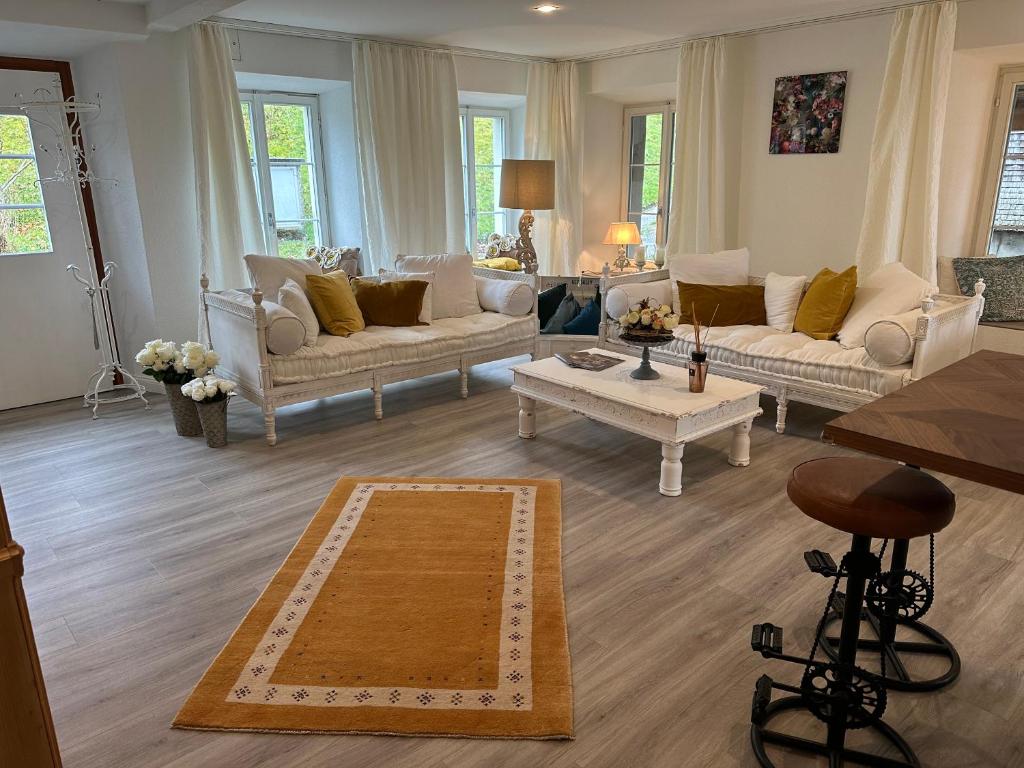 a living room with couches and a coffee table at Allegra Appenzell in Trogen