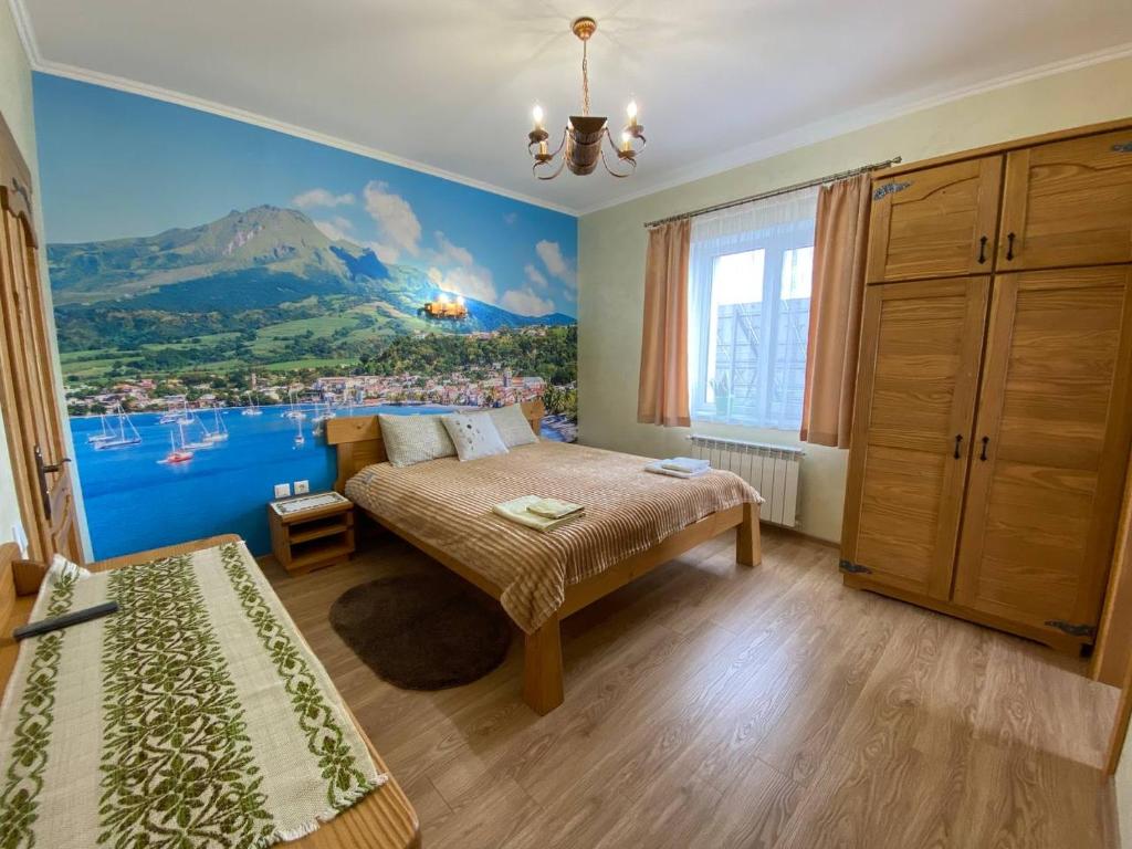 um quarto com uma cama e um quadro na parede em Villa OkSun em Skhidnitsa