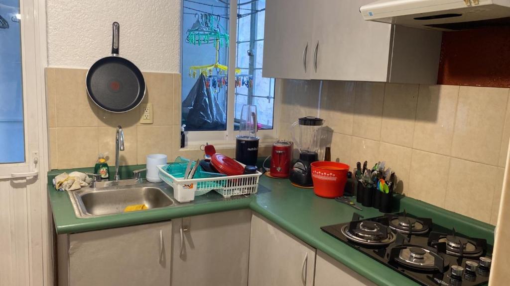 a kitchen counter with a sink and a stove at PISO 1 in Cuautitlán Izcalli