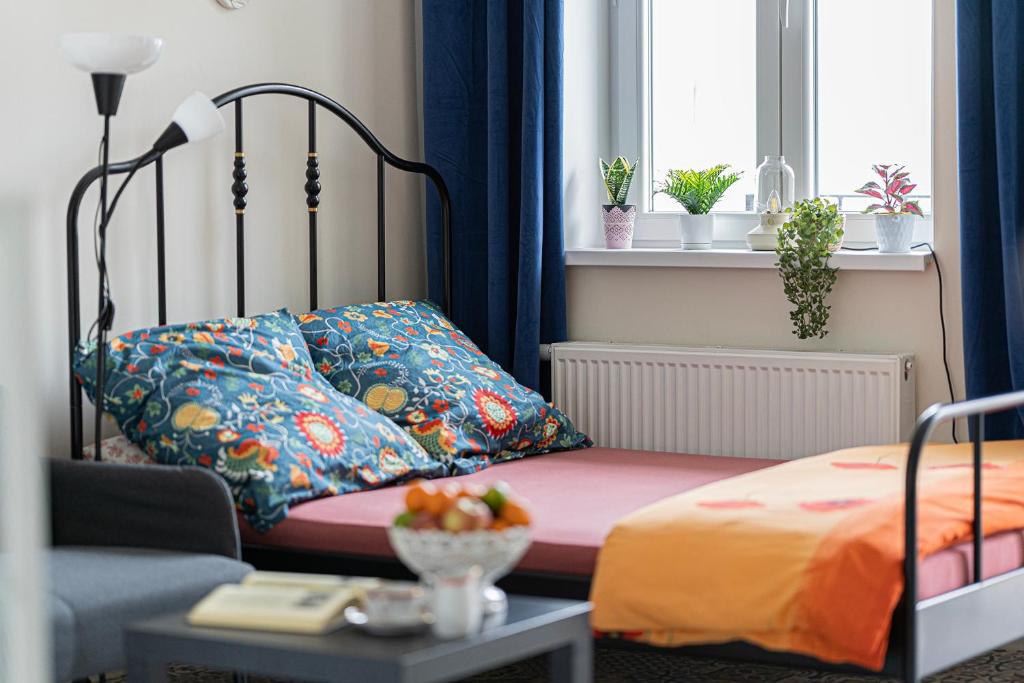 a bedroom with a bed with a pillow and a chair at Apartament u Olechny 3 in Bydgoszcz