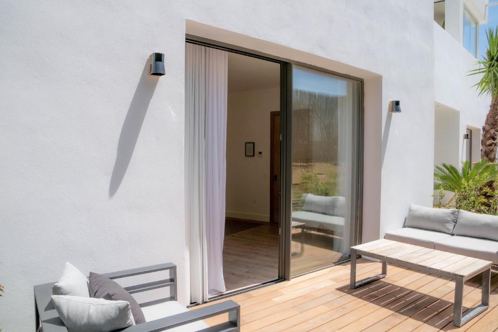 a patio with a couch and a table at Casa Bodhi Boutique Hotel & Spa in Marbella