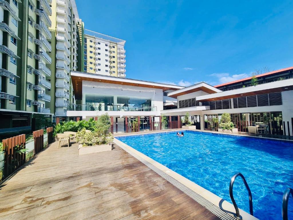 a swimming pool in the middle of a building at Spacious Combine Family Unit Condo at Mesaverte Residences downtown near SM Gaisano Robinson and Centrio in Cagayan de Oro