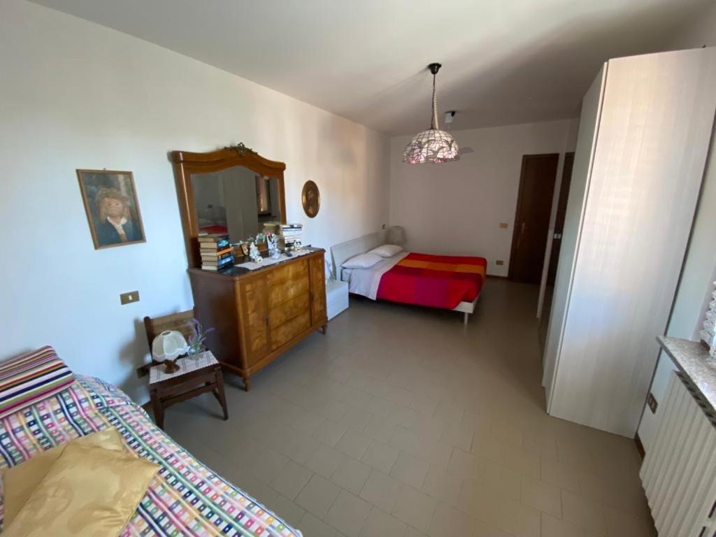 a bedroom with a bed and a dresser and a mirror at Gloria's house in Zerbolò