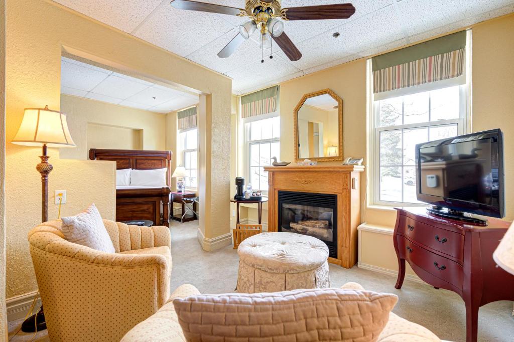 a living room with a couch and a tv and a fireplace at The Stratford Hotel by Hoco Hotels Collection in Stratford