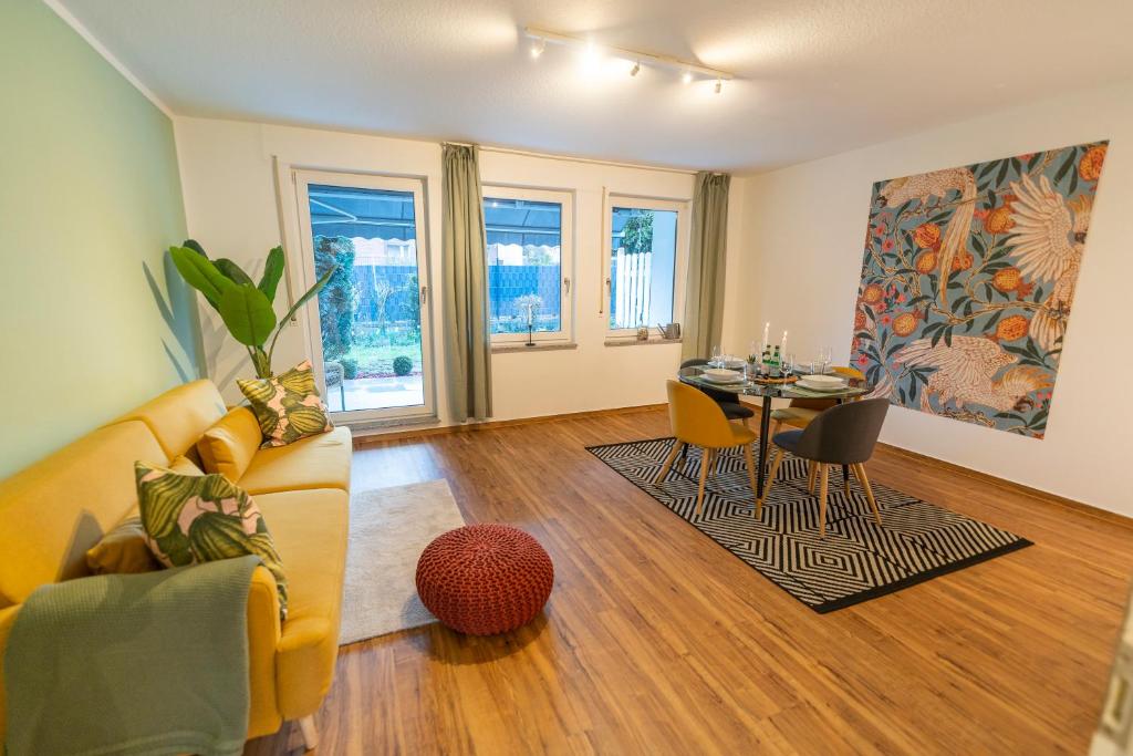 a living room with a couch and a table at RR - Unique Apartment 70qm - Terrace - Washer in Magdeburg