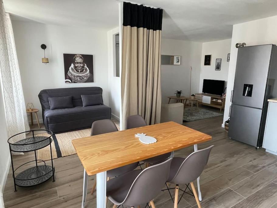 ein Wohnzimmer mit einem Tisch und einem Sofa in der Unterkunft Très bel appartement, port Sanary, in Sanary-sur-Mer